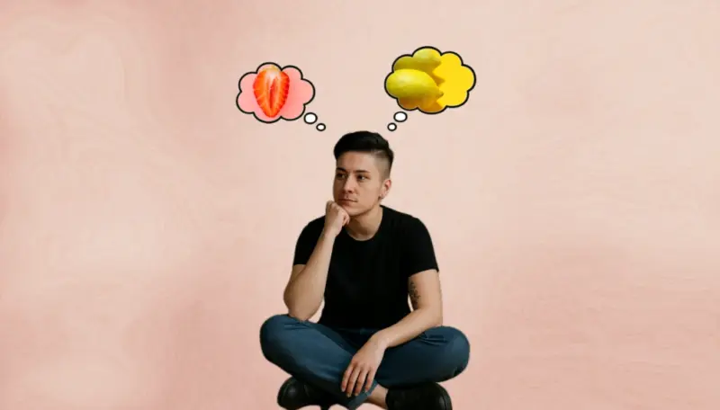 Изображена женщина, вероятно, лесбиянка, задумавшаяся, рядом с ней облачка мыслей, как в комиксах, в одном облачке клубника, на срезе немного напоминающая вульву, в другом пара лимонов, их края слегка напоминают грудь