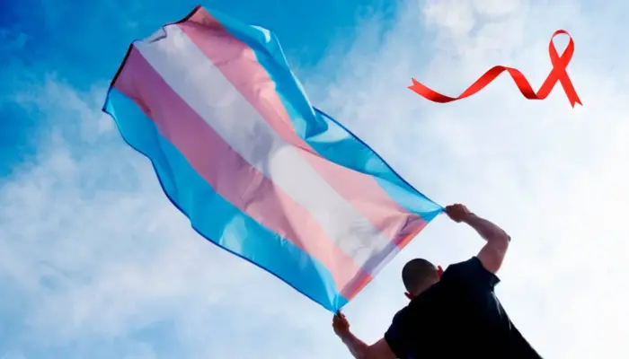 человек несёт транс флаг на фоне неба, поверх изображения красная лента - символ ВИЧ